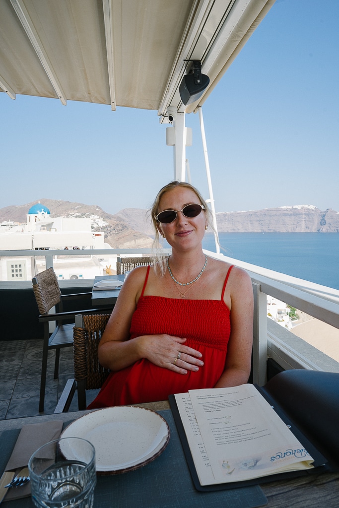 ruth nuss at a restaurant with a view in santorini