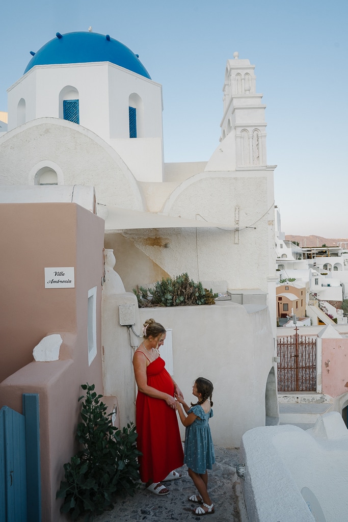 ruth nuss and her daughter standing together in Oia Santorini, greece with kids