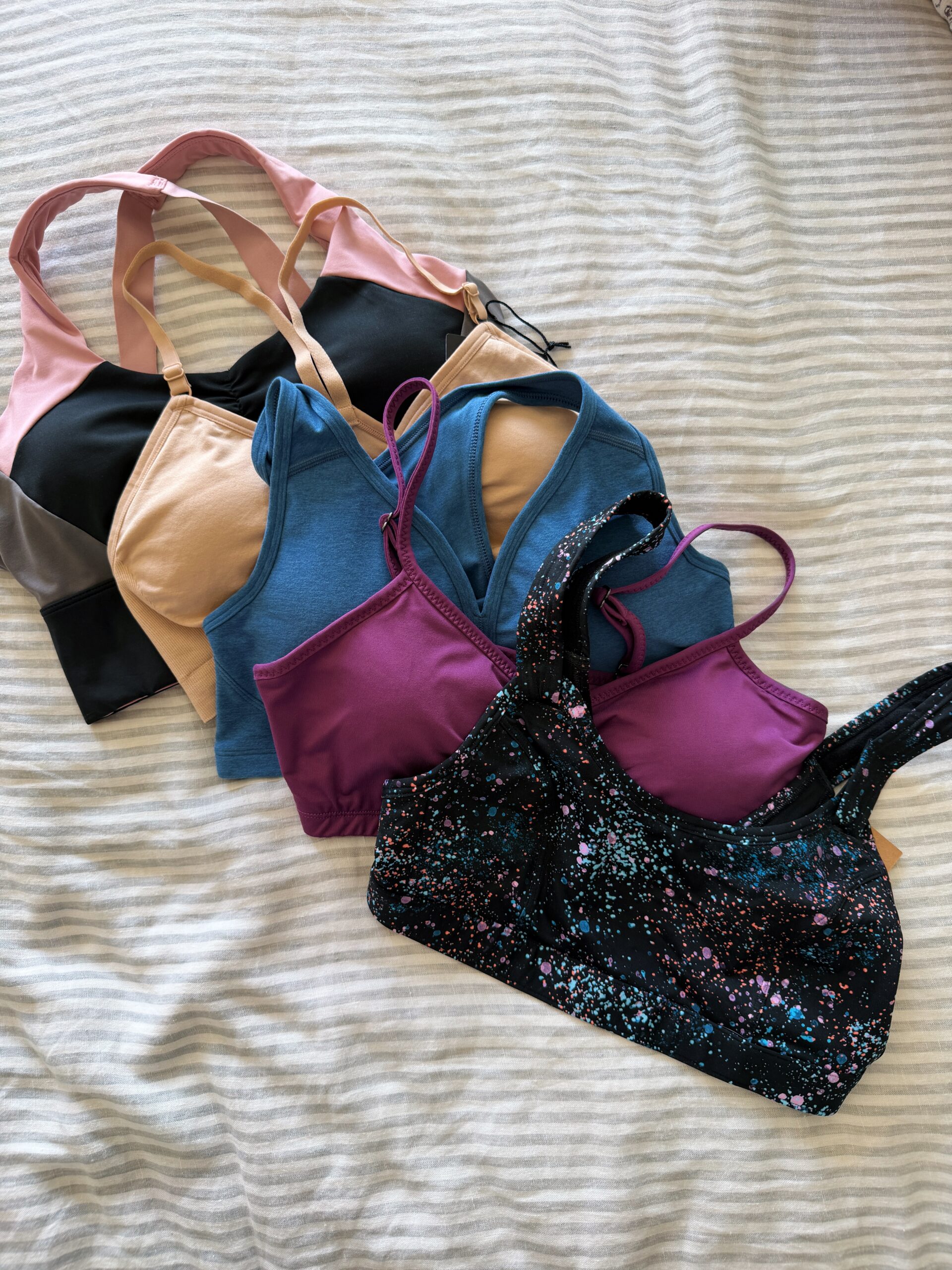 a pile of sports bras from title nine womens clothing